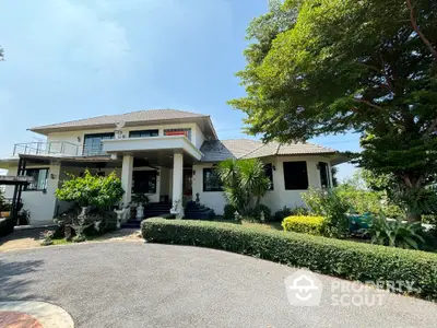 Stunning two-story house with lush garden and spacious driveway