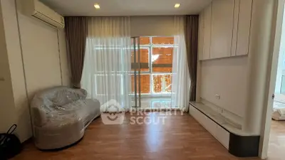 Spacious living room with large windows and modern furnishings