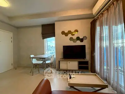 Modern living room with stylish decor and city view, featuring a cozy seating area and dining table.