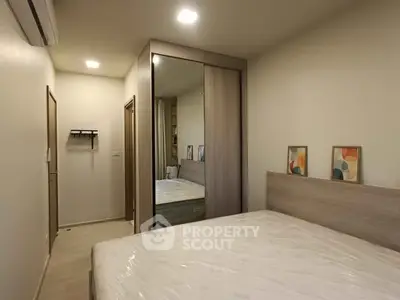 Modern bedroom with mirrored wardrobe and minimalist decor