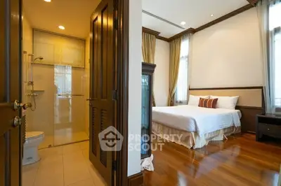 Spacious bedroom with ensuite bathroom in elegant apartment