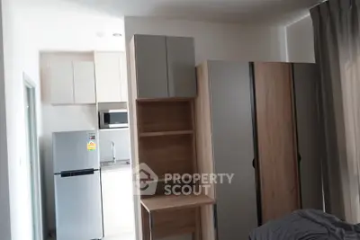 Modern compact kitchen with sleek cabinets and appliances in a cozy apartment