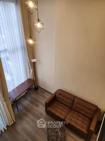 Modern living room with high ceiling and stylish lighting