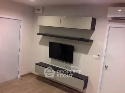 Modern living room with sleek wall-mounted TV and stylish storage cabinets.