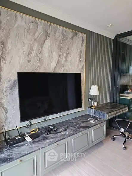 Modern living room with sleek TV setup and stylish marble accents