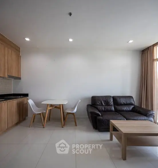 Modern living room with sleek furniture and open kitchen layout