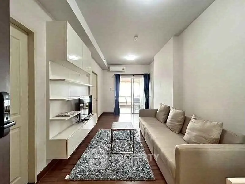 Modern living room with sleek design, cozy sofa, and stylish shelving unit, perfect for urban living.