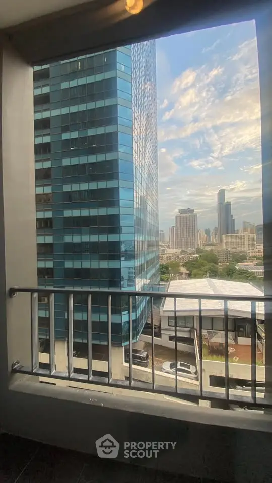 Stunning urban view from a high-rise balcony overlooking city skyline and modern architecture.