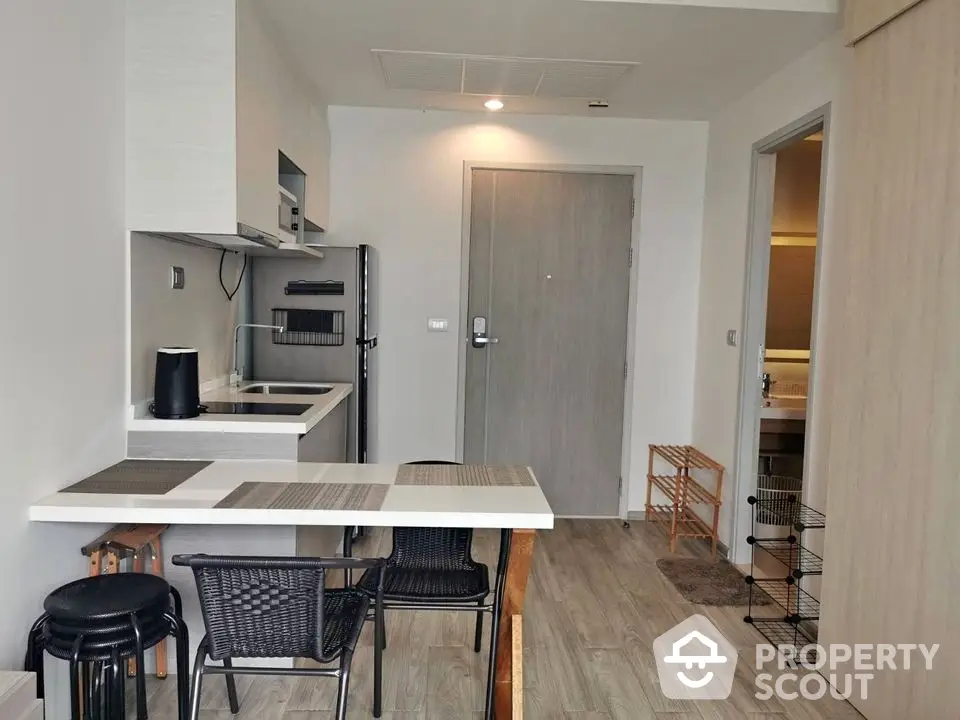 Modern compact kitchen with dining area in stylish apartment