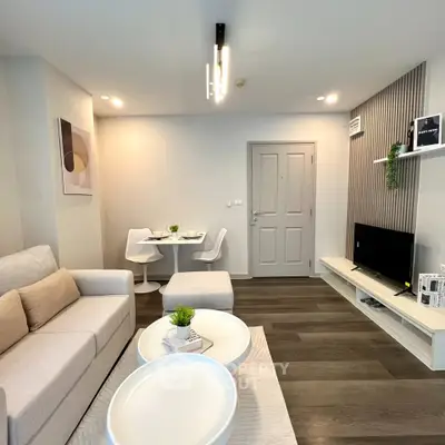 Modern living room with stylish decor and cozy seating area, perfect for relaxation and entertainment.
