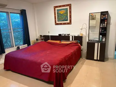Spacious bedroom with large bed and modern decor, perfect for relaxation and comfort.
