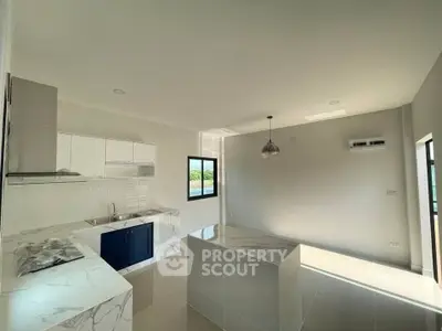 Modern kitchen with marble countertops and open layout in bright apartment