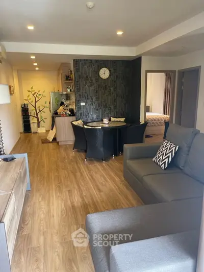 Modern open-plan living room with stylish decor and cozy seating area.