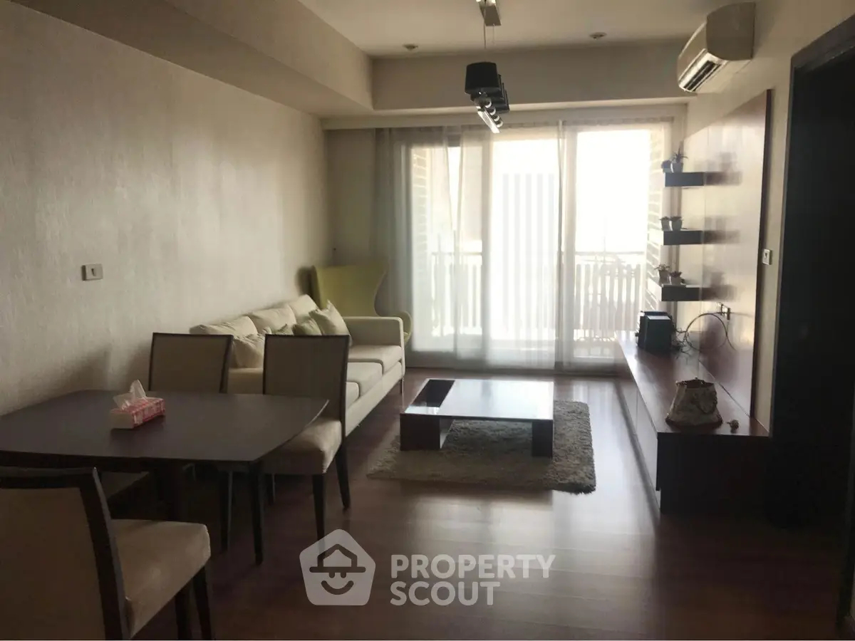 Spacious living room with modern furniture and large windows in a stylish apartment.