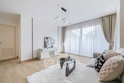 Spacious modern living room with elegant decor and large windows for natural light.