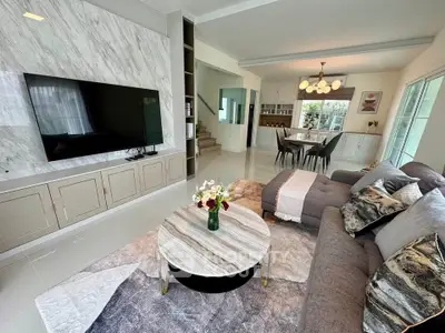 Luxurious living room with modern decor, open layout, and elegant dining area in a stylish home.