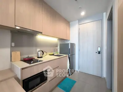 Modern kitchen with sleek cabinetry and stainless steel appliances in a compact layout.