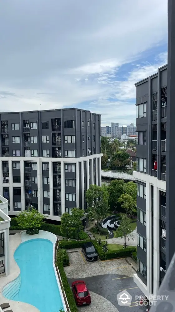 Modern apartment complex with pool and city view