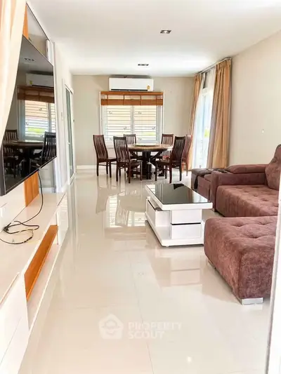 Spacious living room with modern furniture and large windows for natural light.