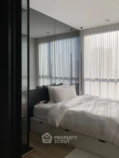 Modern bedroom with floor-to-ceiling windows and sleek design