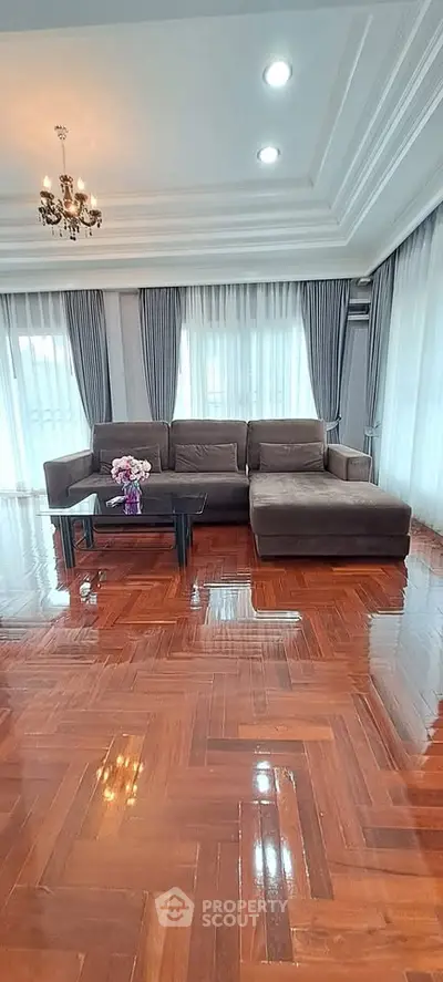 Spacious living room with elegant sofa and polished wooden floors