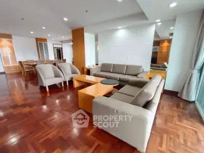 Spacious modern living room with elegant wooden flooring and cozy seating area.