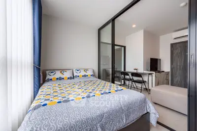 Modern bedroom with stylish decor and natural light in a contemporary apartment.