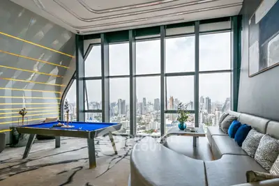 Luxurious living room with panoramic city view and modern pool table.