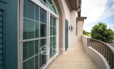 Elegant balcony with arched windows and scenic view in luxury home