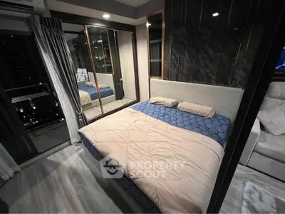 Modern bedroom with stylish decor and city view, featuring a cozy bed and elegant furnishings.
