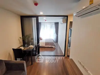 Modern studio apartment with glass partition and cozy dining area