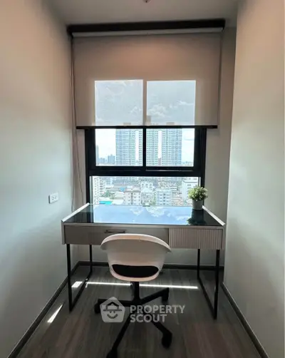 Modern study nook with city view, featuring sleek desk and chair, perfect for productivity.