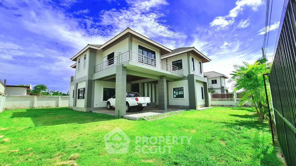 Stunning modern two-story house with lush green lawn and spacious driveway