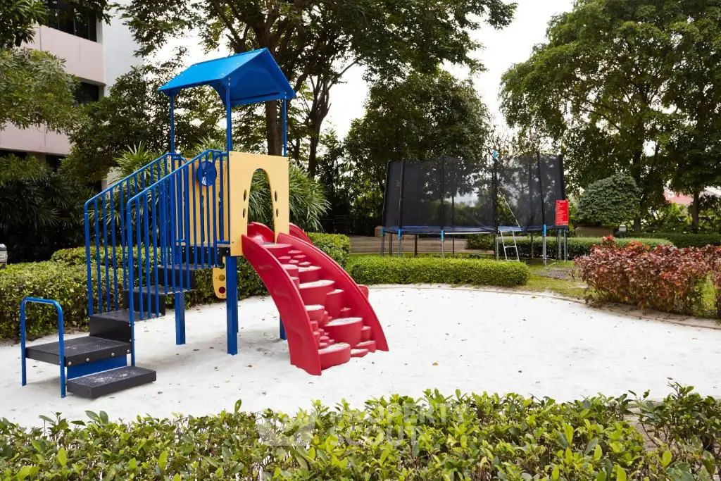 Charming playground area in a lush garden setting, perfect for family-friendly living.