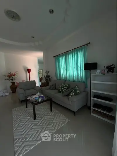Cozy living room with modern furniture and natural light, perfect for relaxation and entertaining.