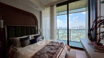 Luxurious bedroom with stunning city view and large balcony access.