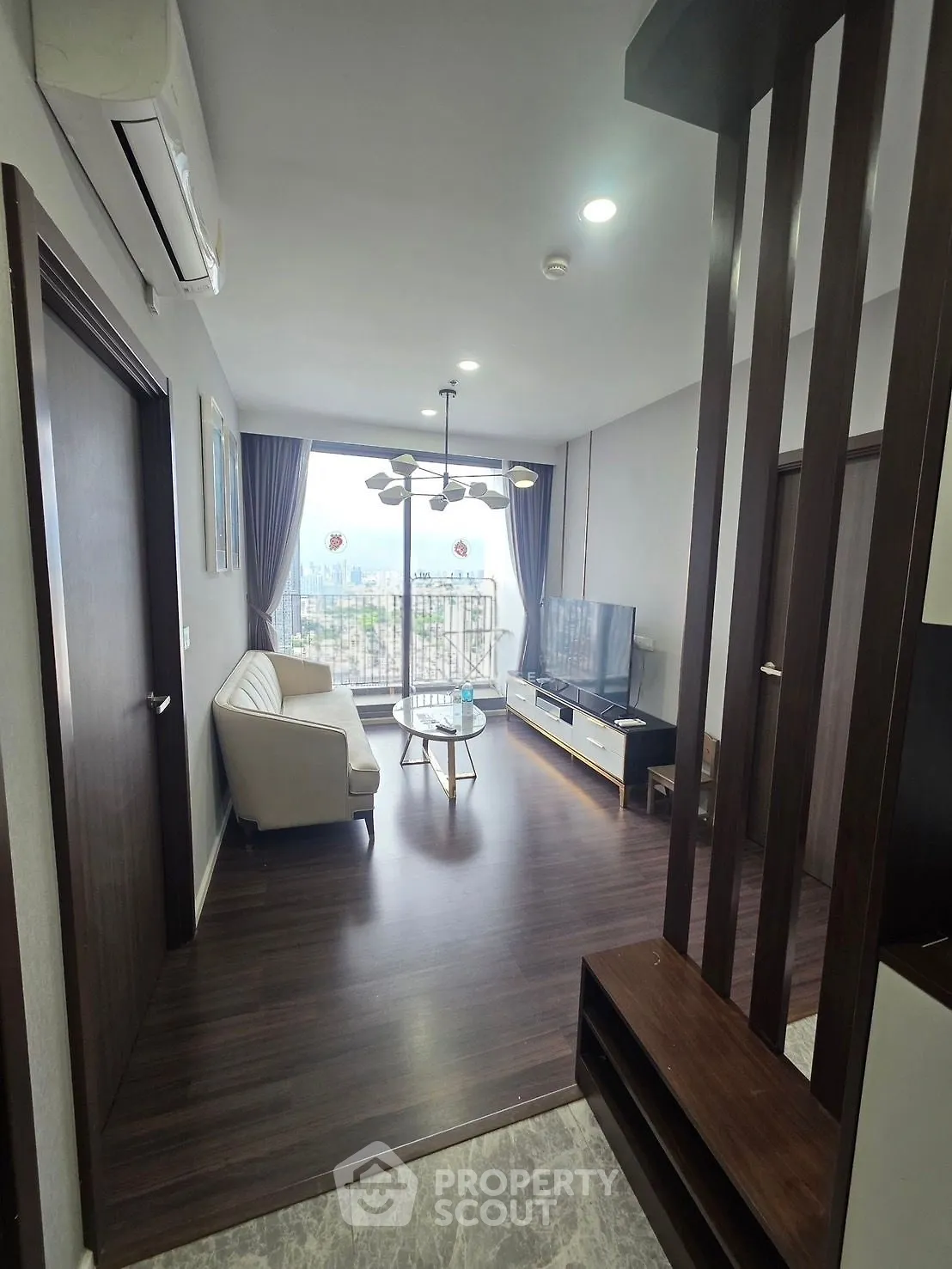 Modern living room with elegant decor and city view balcony