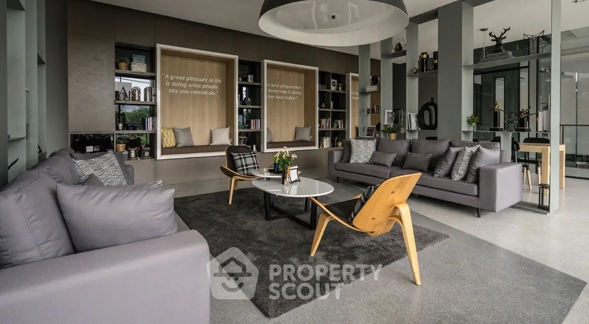 Spacious modern living room with stylish furniture and large windows, perfect for relaxation and entertaining.