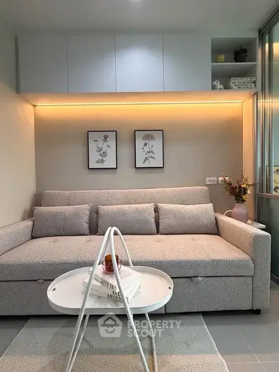 Modern living room with cozy sofa, stylish decor, and ambient lighting.