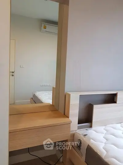 Modern bedroom with stylish wooden furniture and comfortable mattress