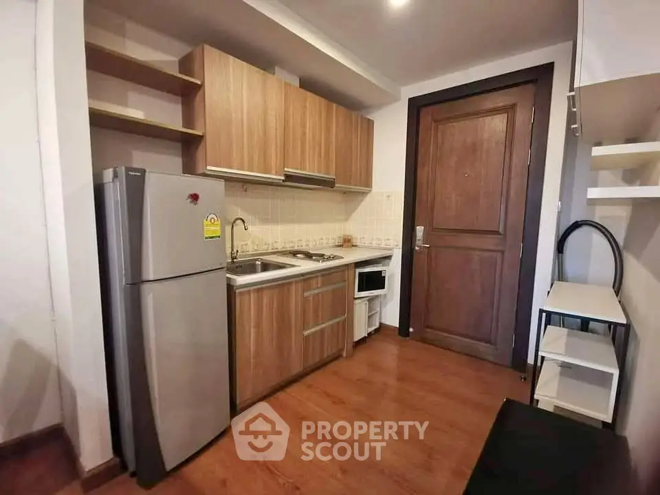 Cozy kitchen with wooden cabinets and modern appliances in a compact layout