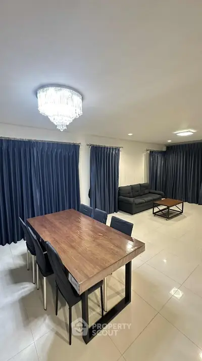 Spacious modern living room with elegant dining area and chic lighting