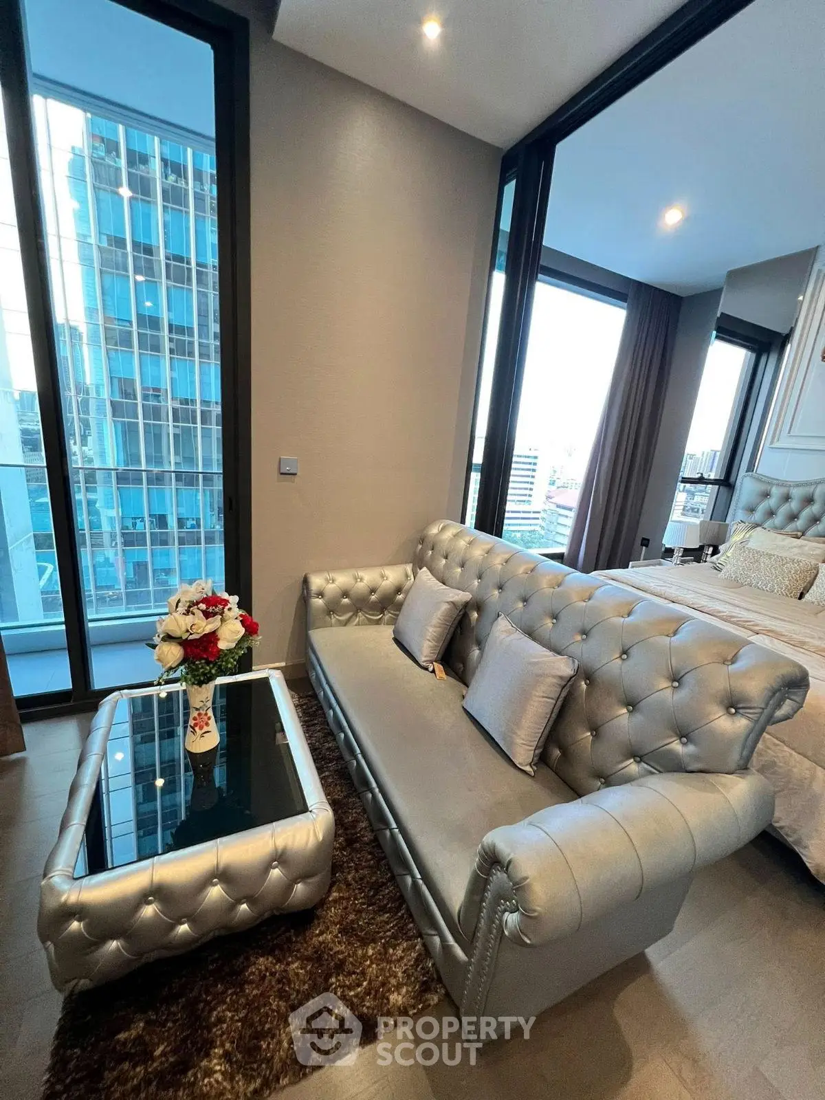 Luxurious modern living room with elegant silver sofa and city view
