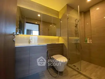 Modern bathroom with sleek design, glass shower, and elegant fixtures in a contemporary apartment.