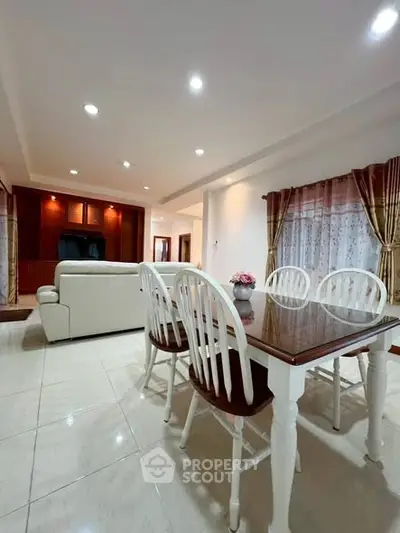 Spacious living room with elegant dining area and cozy seating arrangement.