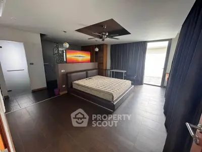 Spacious modern bedroom with large windows and stylish decor
