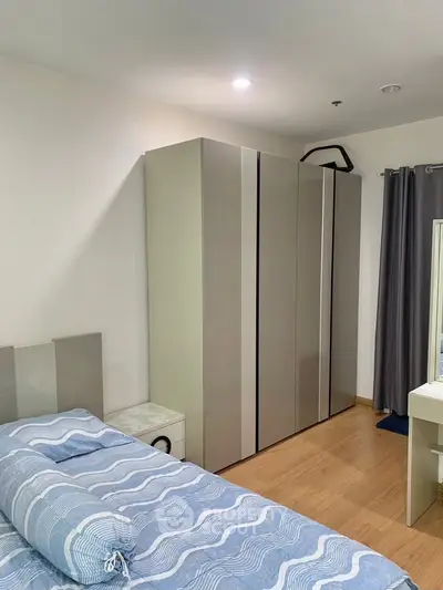 Modern bedroom with sleek wardrobe and cozy bed in stylish apartment.
