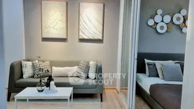 Modern living room with stylish decor and cozy bedroom view, perfect for urban living.