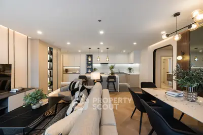 Luxurious open-plan living room with modern kitchen and elegant dining area, perfect for entertaining.