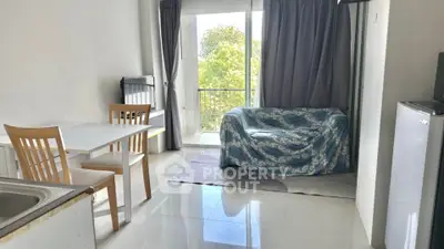 Bright living room with balcony view and cozy dining area
